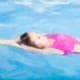 Beautiful woman swimming in pool