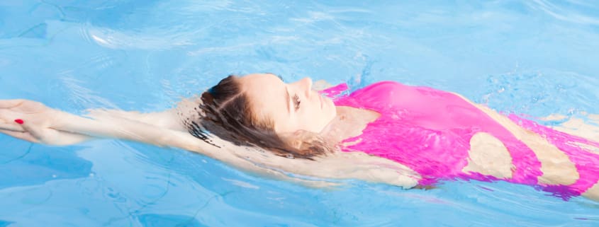 Beautiful woman swimming in pool