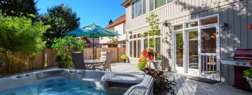 Backyard with hot tub and patio area