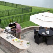 Man cooking meat on a gas BBQ