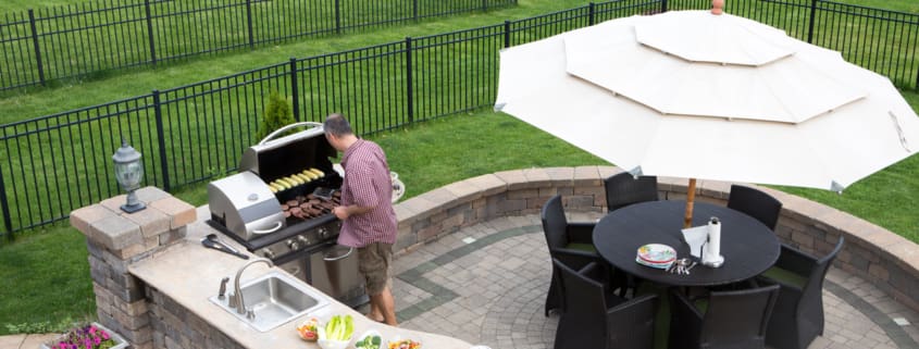 Man cooking meat on a gas BBQ