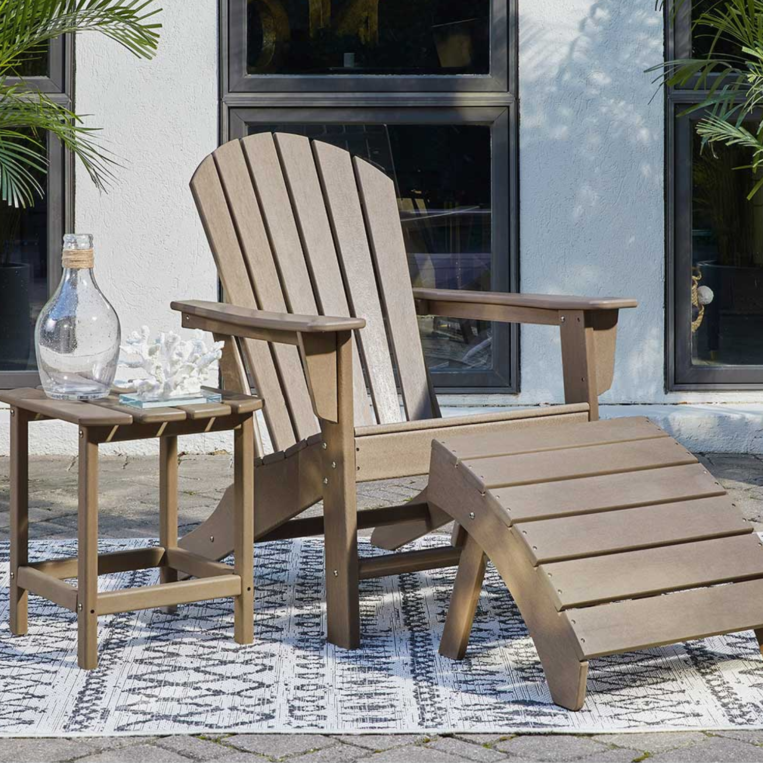 Classic wooden Adirondack chair with ottoman and side table, a timeless option for Patio Furniture near me.